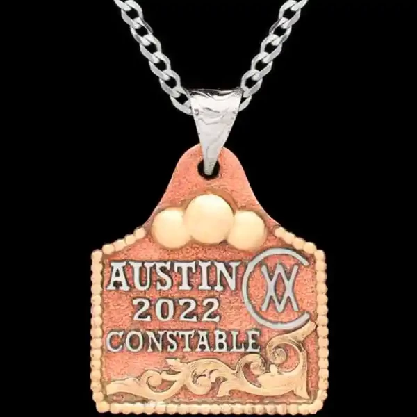 Meet our Muffin Cow Tag Necklace, crafted on a hand matted copper base, adorned with golden Jeweler's Bronze scrollwork and a charming bead edge. Customize it with your lettering and ranch brand now!